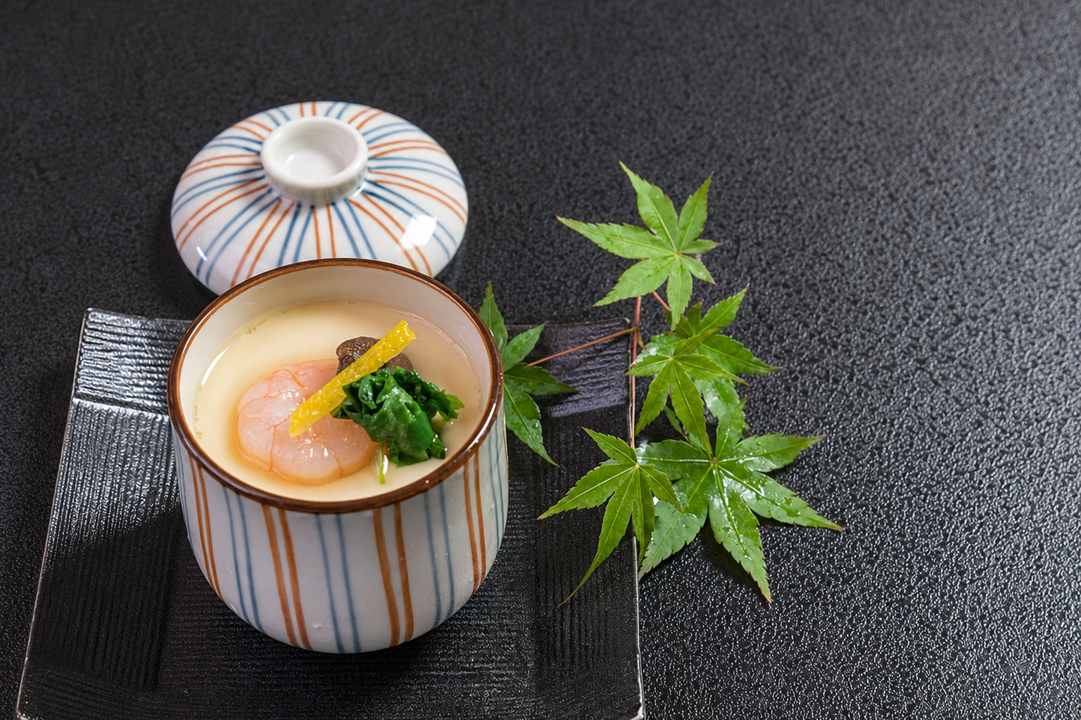 Japanese chawanmushi with scallop, seaweed and yuzu garnish