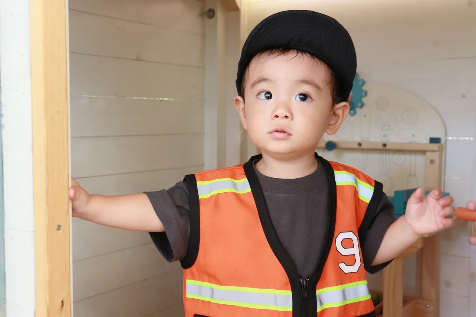 Portrait of child in orange Thai motorcycle taxi style vest costume