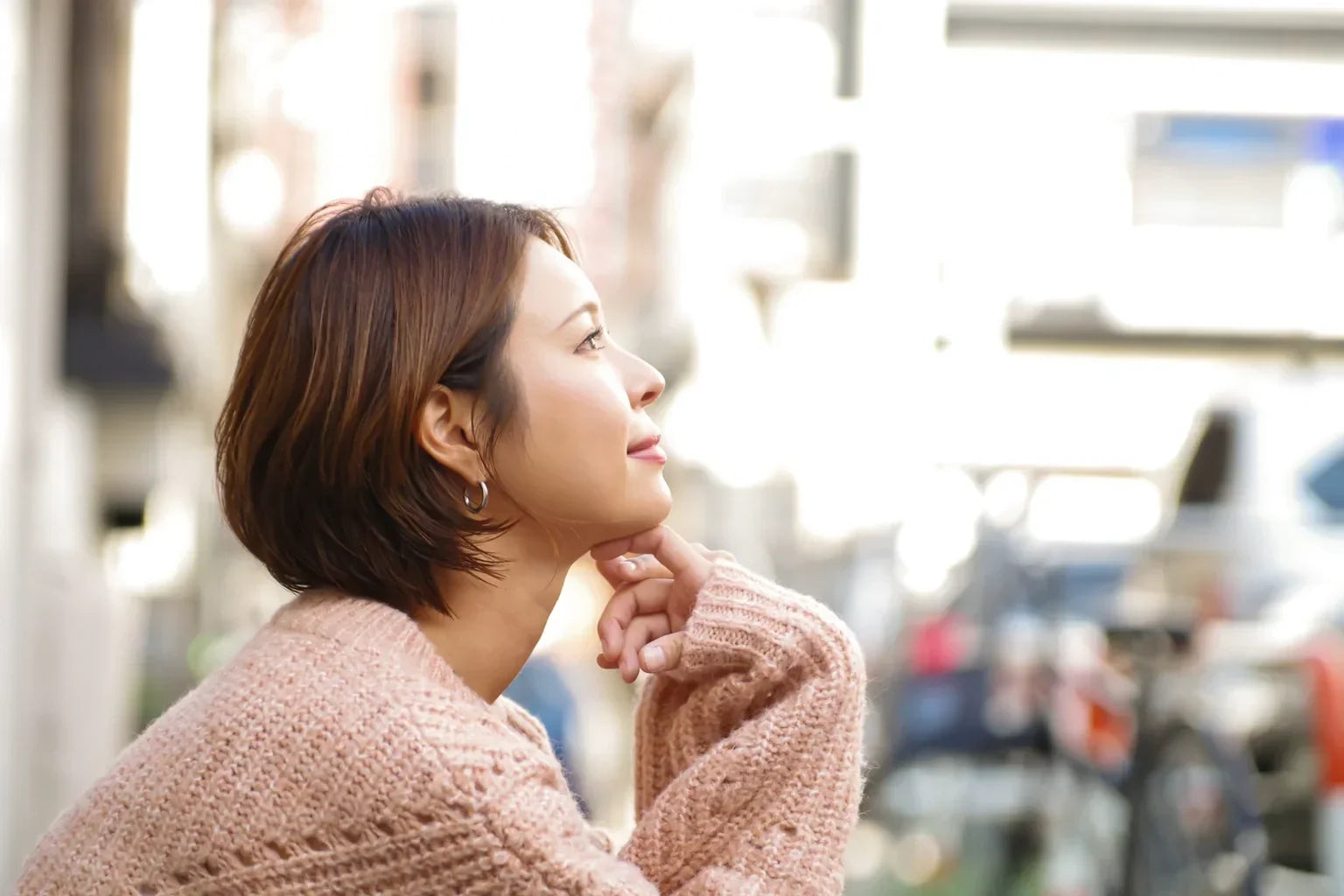 A Japanese woman enjoying a quiet moment in a lifestyle image for ONSENSUI99 from Japan.