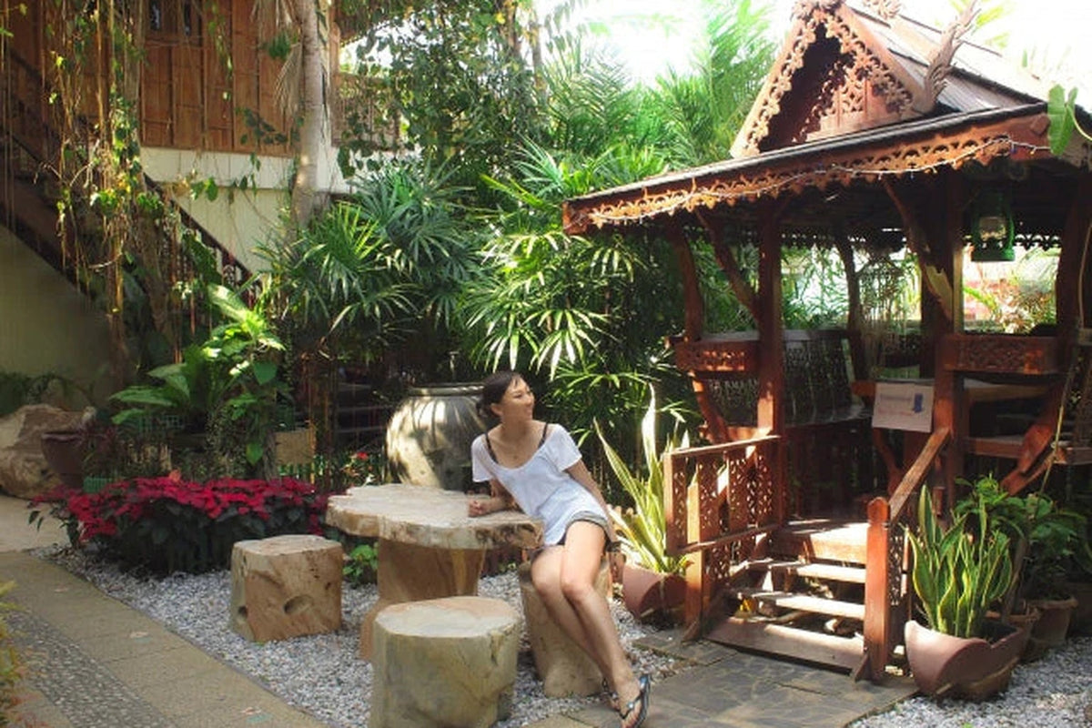 タイのリゾートホテルで自然に囲まれてくつろぐ女性|旅の健康と美容を整える時間