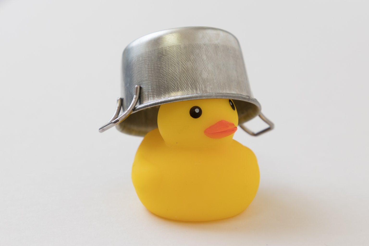 Rubber duck wearing pot as helmet representing disaster awareness