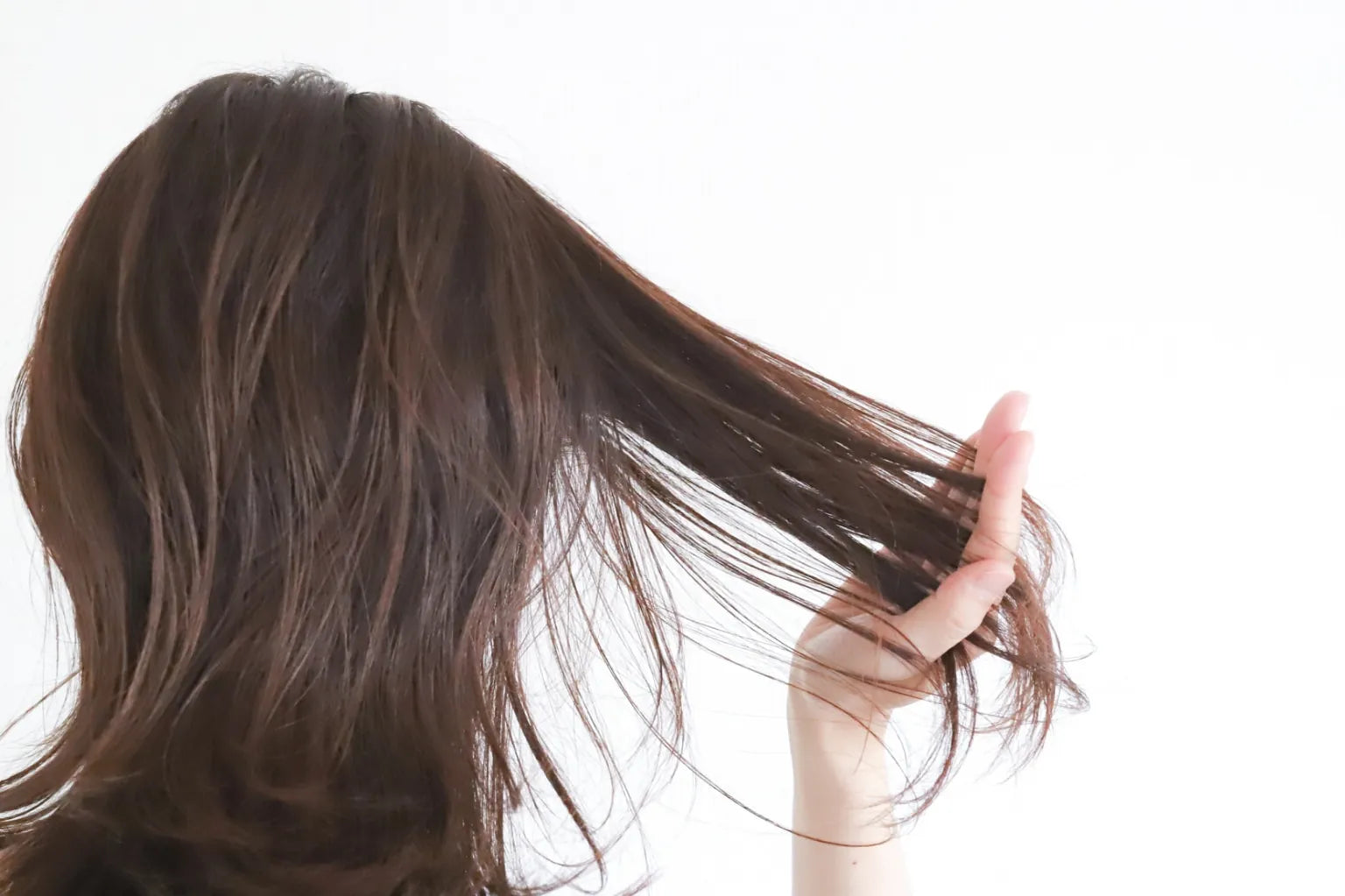 なめらかな髪質を触る女性 超軟水による髪のまとまりとツヤのイメージ
