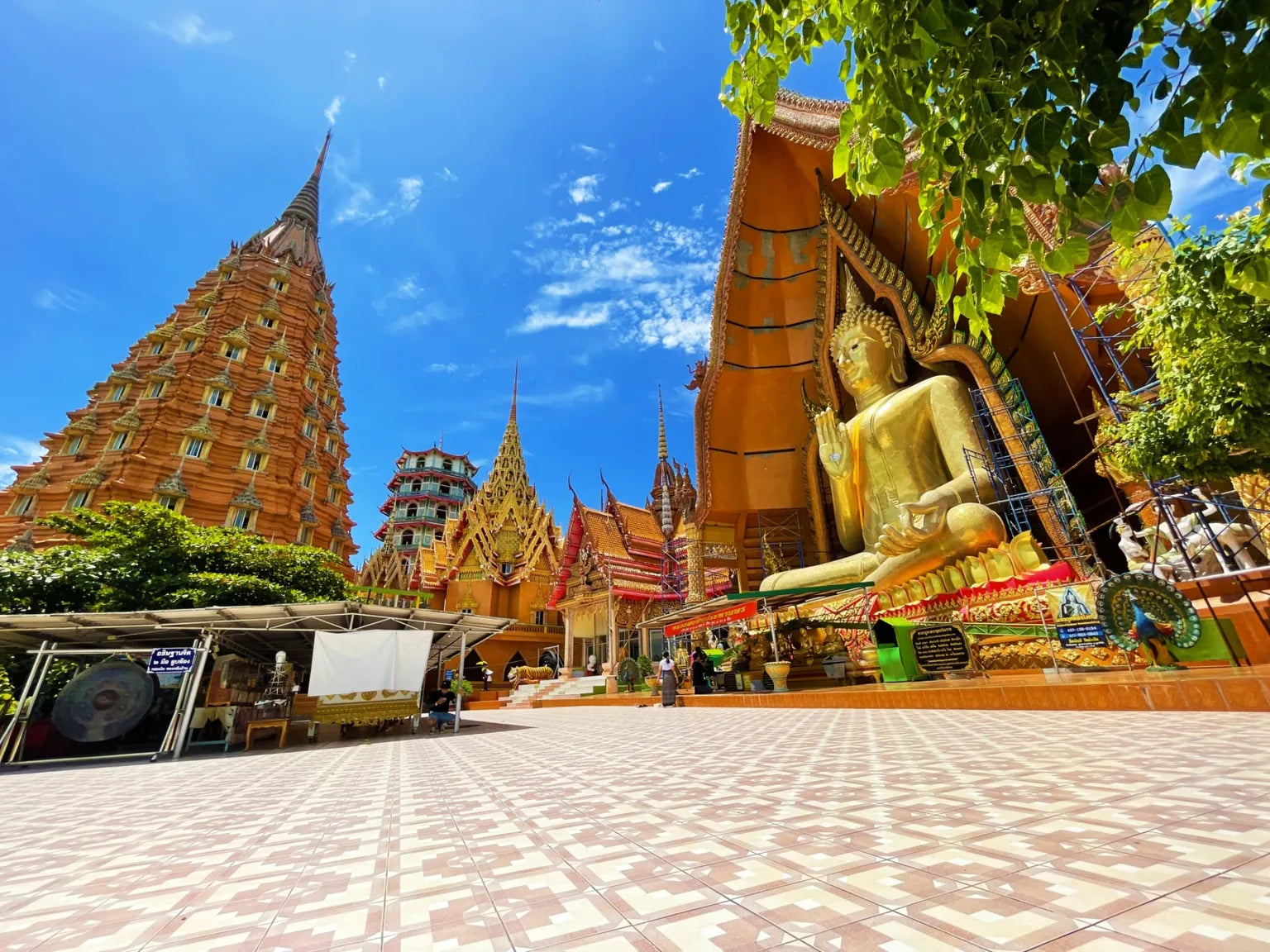 Golden Buddha statue at famous Thailand temple cultural travel landmark