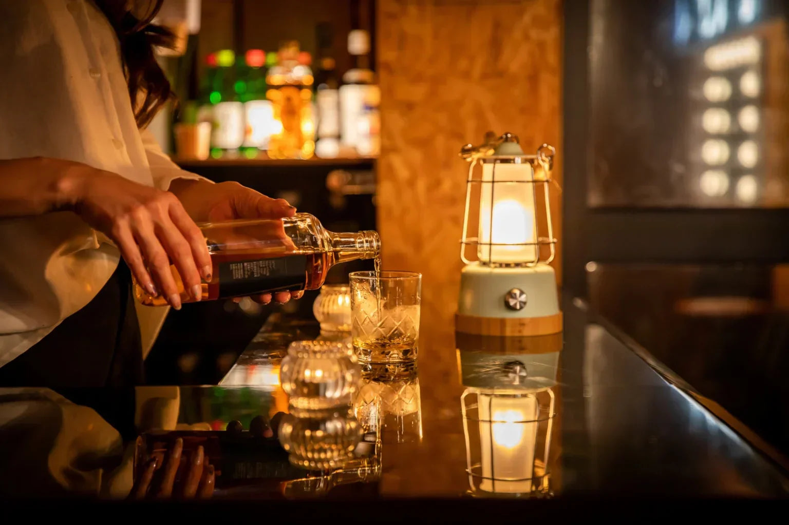bartender pouring whiskey with water chaser bar scene