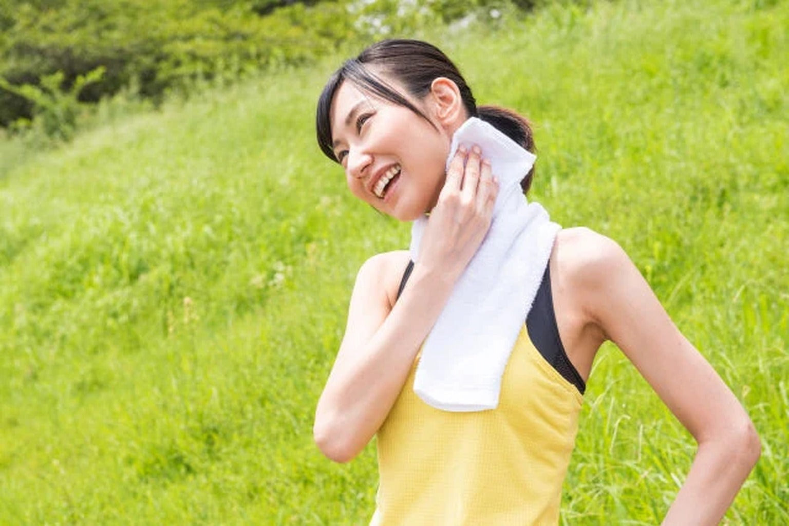 Woman cooling down after exercise with towel, hydration lifestyle image