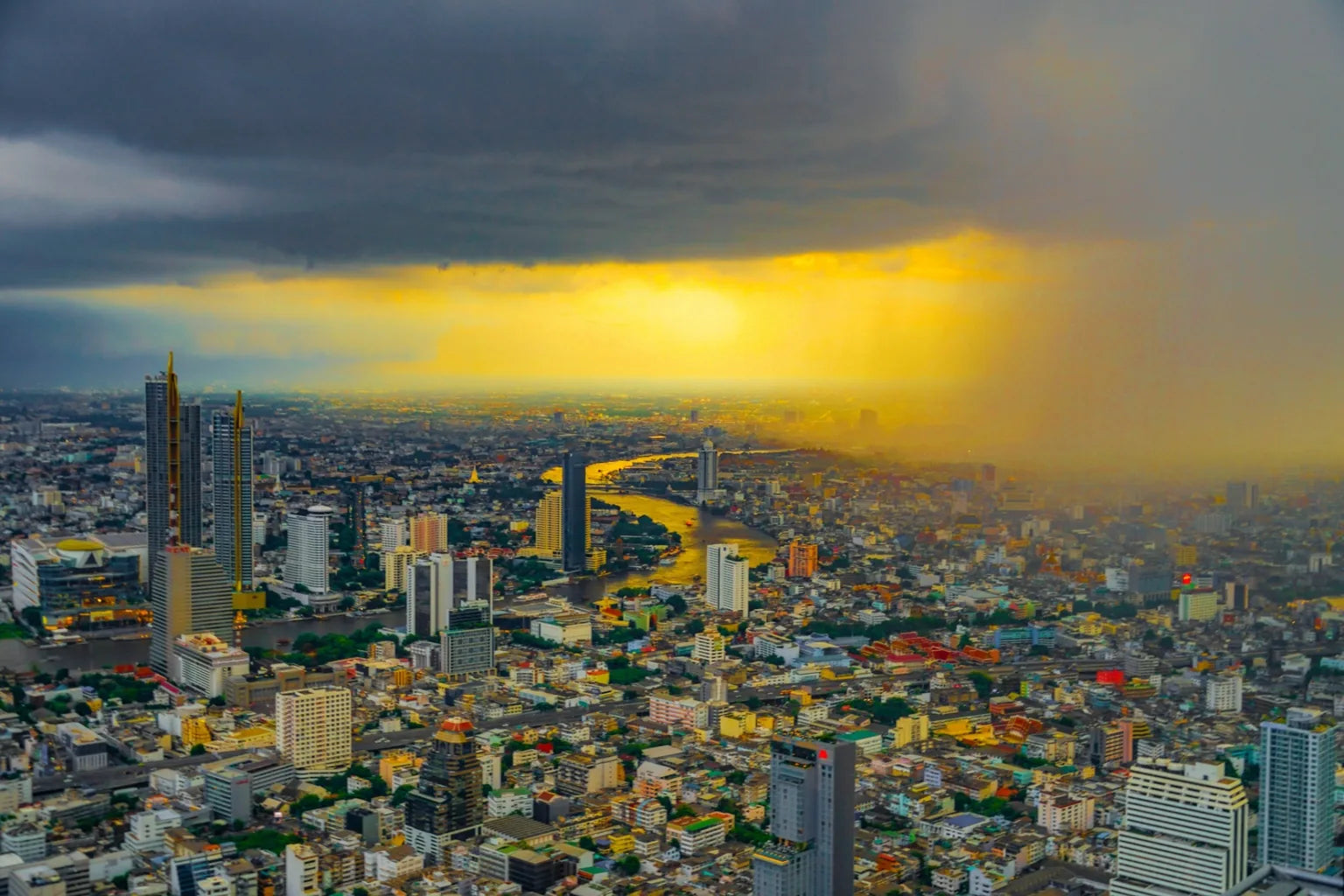 Bangkok storm clouds and rain over Chao Phraya River cityscape