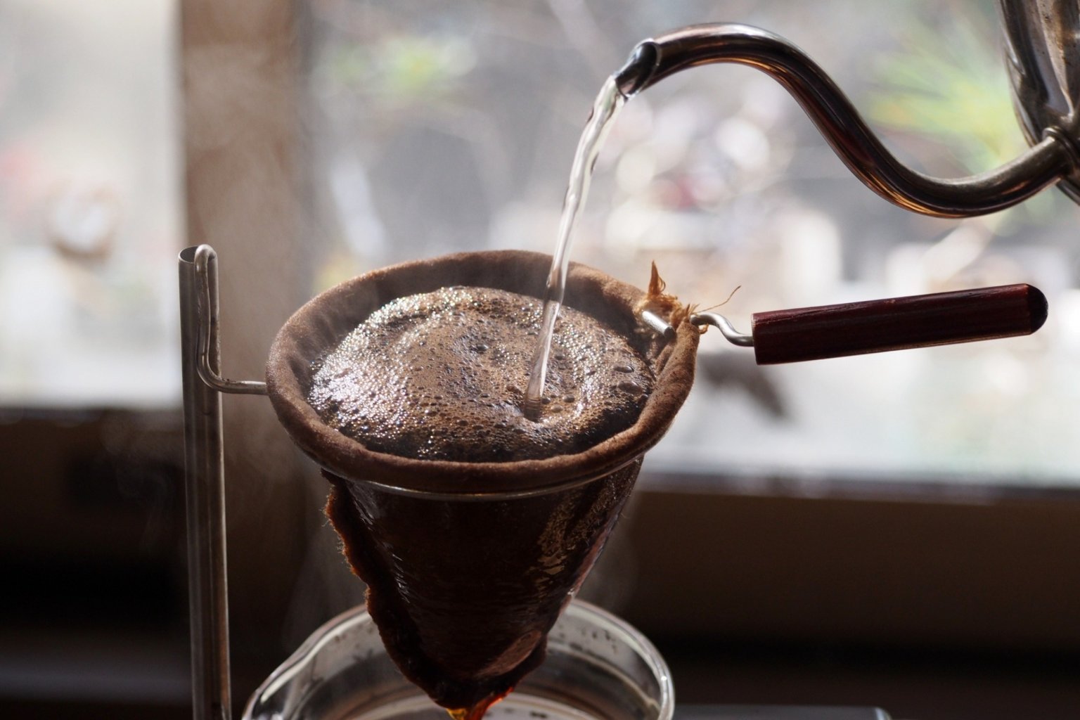 hand drip coffee brewing with cloth filter showing extraction process