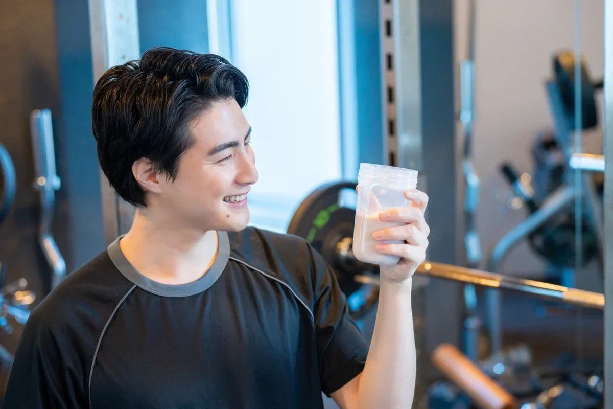 Man drinking protein shake during workout for hydration and performance support
