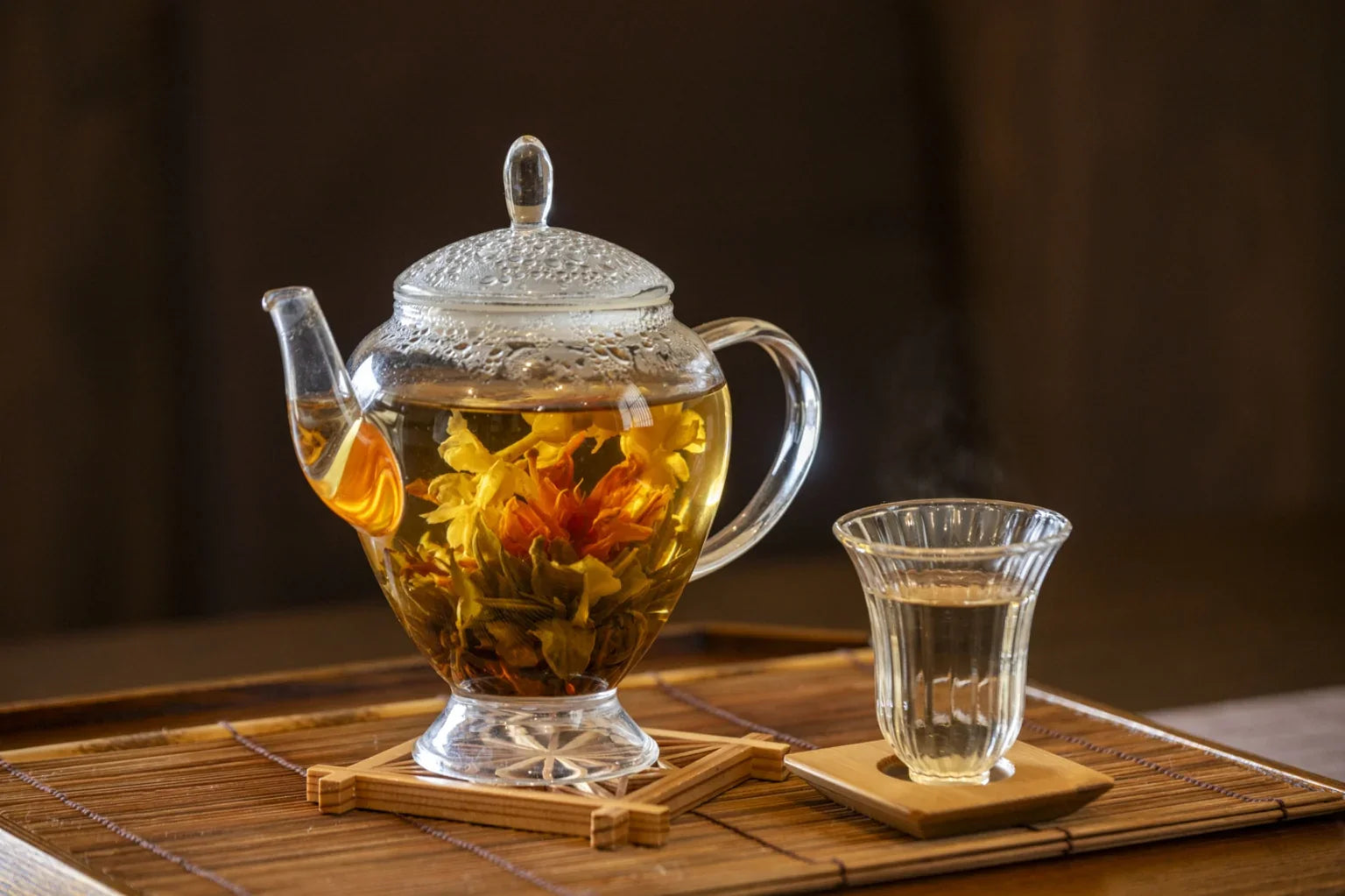 A glass teapot with herbal tea made using soft water, representing a premium Japanese detox lifestyle with gentle hydration.