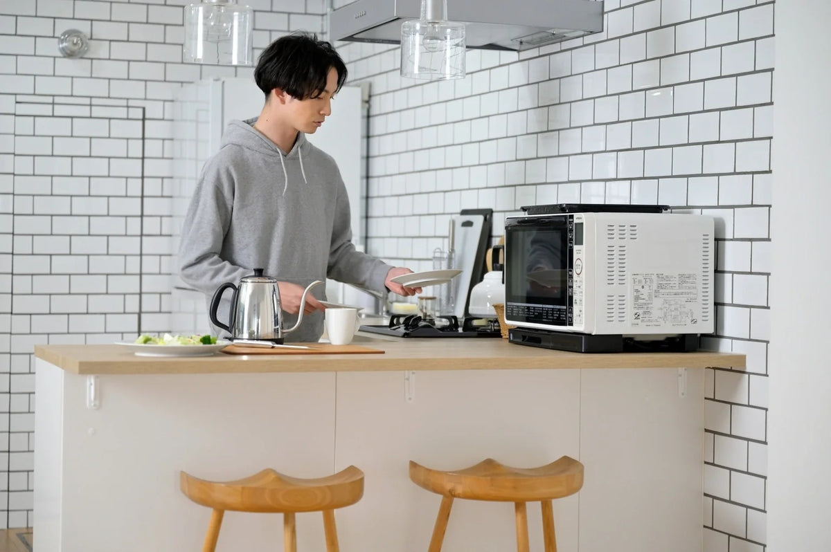 Man preparing a simple meal at home as part of a Japanese single-person lifestyle
